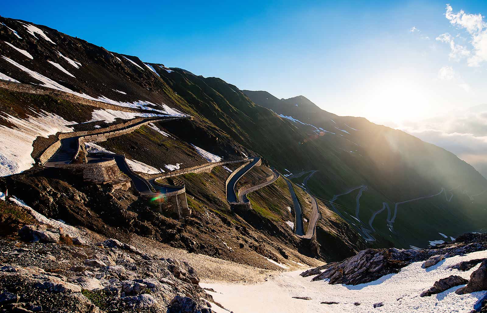 The winding road that leads to passo dello Stelvio covered with little snow