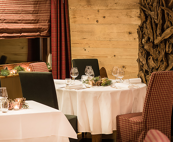 Tavola apparecchiata con tovaglia a quadretti nella sala da pranzo dell'Hotel Alù